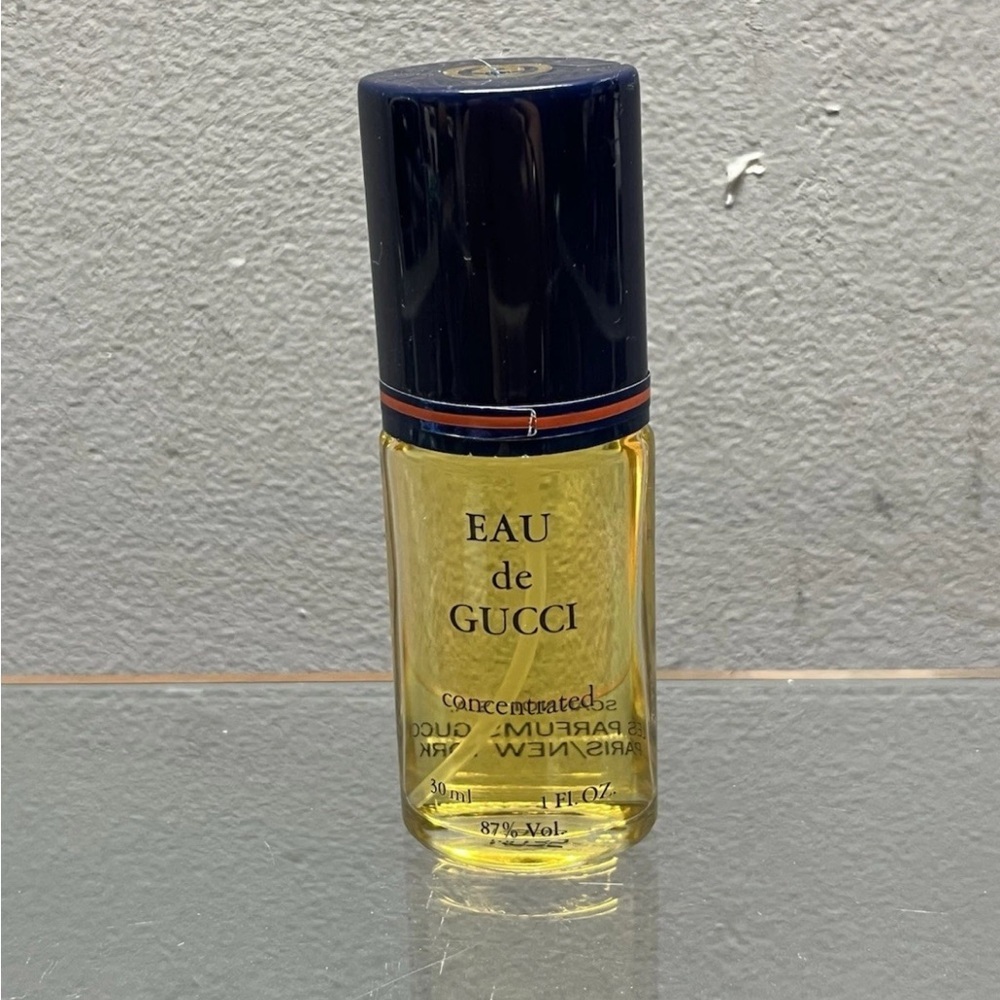 Gucci Fragrance with Black Cap and Golden Hue